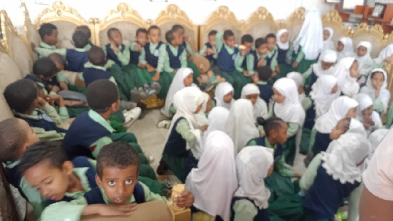 Students seated together for an indoor assembly